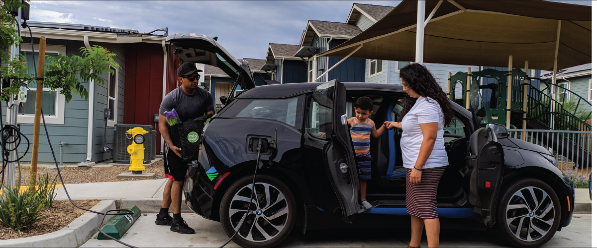 A family exiting their electric vehicle